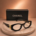 CHANEL Black Oval Eyeglasses – Glossy Acetate Frame with Gold CC Logo
