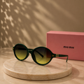 MIU MIU Dark Green Round Sunglasses – Yellow-to-Green Gradient Lenses with Gold Monogram Hardware