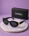 CHANEL Black Oval Sunglasses – Glossy Acetate Frame with Gold CC Logo Temples