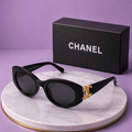 CHANEL Black Oval Sunglasses – Glossy Acetate Frame with Gold CC Logo Temples