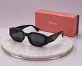 PRADA Symbole Rectangular Geometric Sunglasses – Black Acetate Frame with Gold Triangle Logo