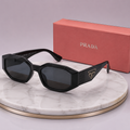 PRADA Symbole Rectangular Geometric Sunglasses – Black Acetate Frame with Gold Triangle Logo
