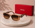 PRADA Symbole Rectangular Sunglasses – Translucent Caramel Brown Acetate Frame