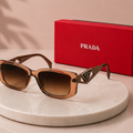 PRADA Symbole Rectangular Sunglasses – Translucent Caramel Brown Acetate Frame
